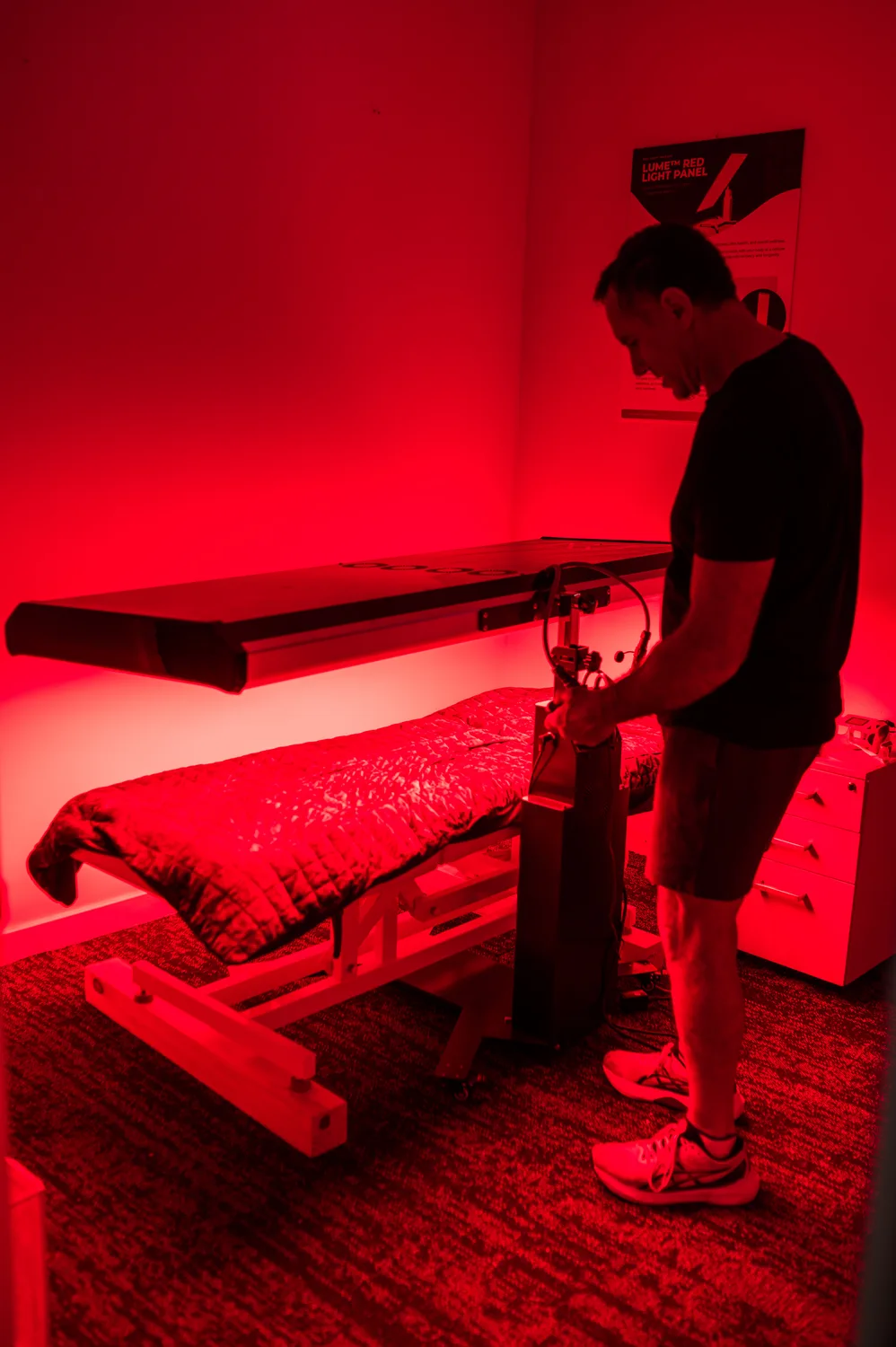 Nate setting up equipment in the red light room