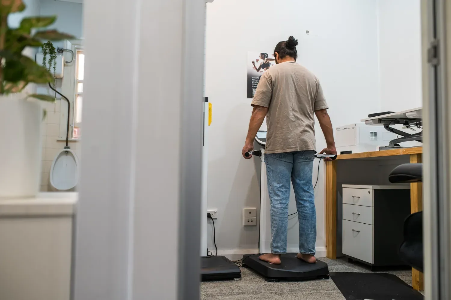 A person standing on a body composition scanner at the Supercell Hub.