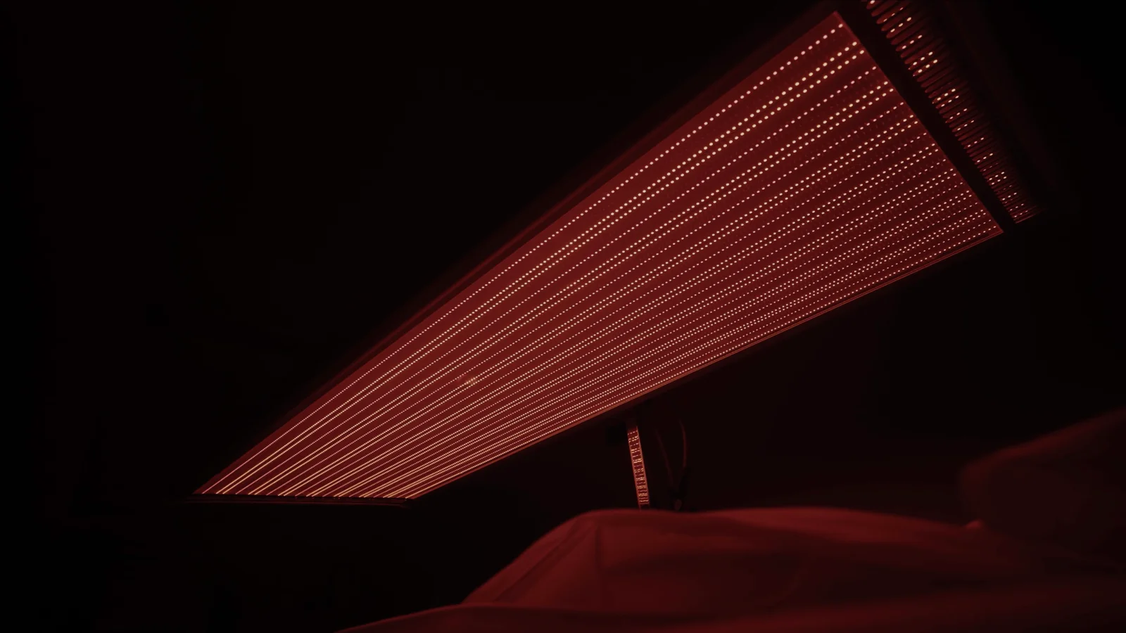 A close-up of the illuminated LEDs on an overhead red-light panel.